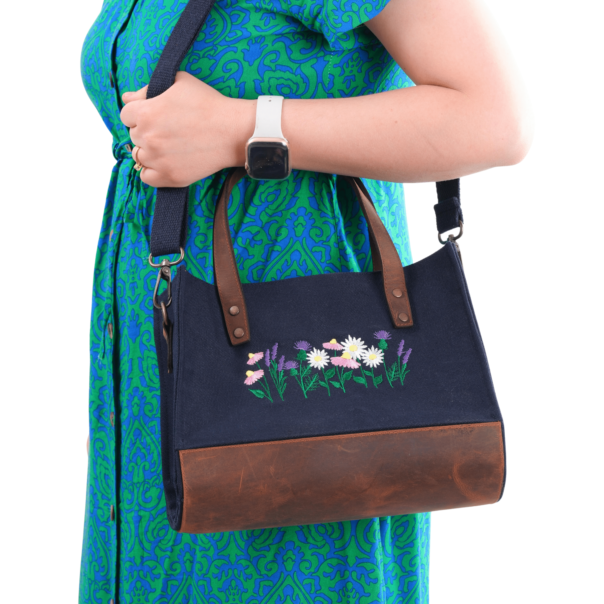 Woman holding a navy canvas embroidered bag with genuine leather strap - Lavender & Daisy design