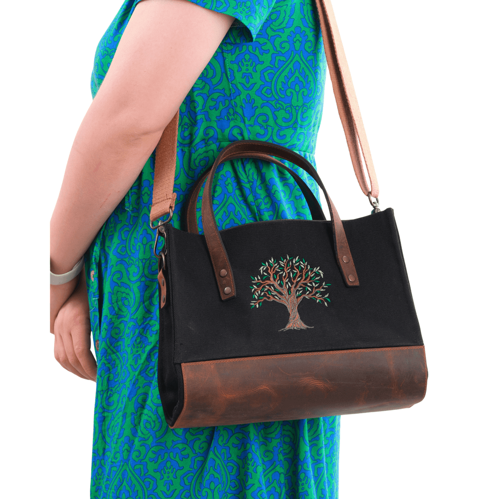 Black canvas Olive Tree embroidered leather shoulder bag on shoulder