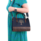 Black canvas Olive Tree embroidered leather shoulder bag worn by model