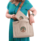 Khaki canvas Tree of Life embroidered shoulder bag held by model